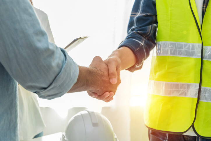 Construction worker shaking hands with contractor