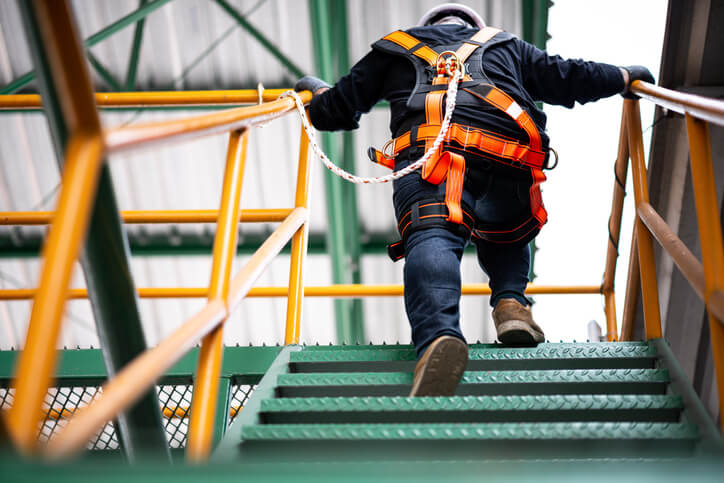Construction worker climbing up stairs
